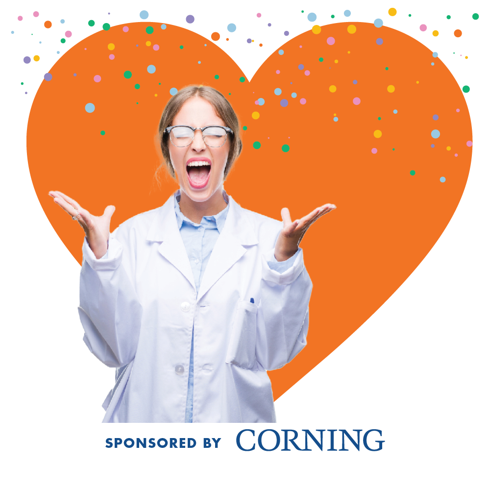 Scientist in front of a large orange heart with colorful confetti. Text at the bottom reads “Sponsored by Corning.”
